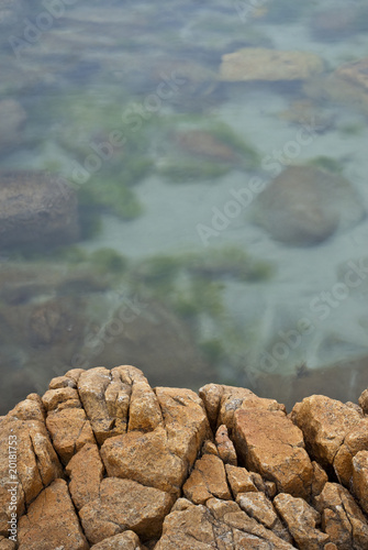 Photo: Rock ledge overlooking calm, clear, seawater Rock ledge overlooking calm, clear, seawater