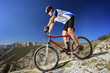 Photo: Person riding a bike downhill style Person riding a bike downhill style