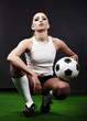 Sexy football  player, woman on playing stadium