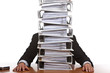 Frustrated Business man in office with huge paperwork (folders)