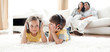 Little boy and little girl playing on the floor with headphones