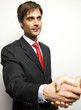 Attractive Young Businessman shaking hands off camera