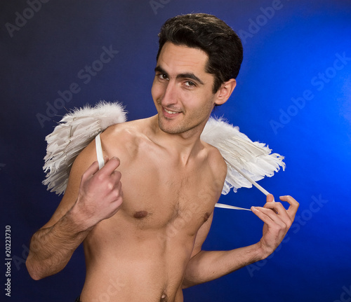 Photo: Glamour man with white wings. Glamour man with white wings.