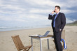 Business man with office on the beach