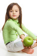 a girl offering a green apple