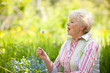 Senior woman with dandelion