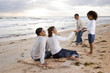 Happy African-American family playing on beach