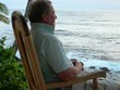 pensive man in rocking chair waterfront caribbean sea