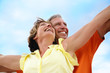 Happy mature couple standing with arms outstretched. Happy mature couple standing with arms outstretched.