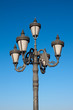 Old fashioned street lamp over blue sky
