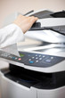 Woman's hand with working copier Woman's hand with working copier