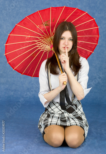 Photo: Girl with red oriental umbrella on blue Girl with red oriental umbrella on blue