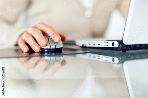 Photo: Cropped image of businesswoman working on laptop Cropped image of businesswoman working on laptop
