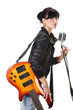 Rock-n-roll girl holding a guitar singing into retro microphone