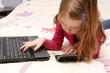 Photo: Girl using laptop and cell phone Girl using laptop and cell phone