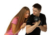 Girl considers a biceps of the man by means of a magnifier. Girl considers a biceps of the man by means of a magnifier.