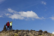 Romantic Couple Hiking Standing Pointing By Stone Pile Tor