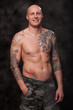 Photo: Man with tattoo's on dark background Man with tattoo's on dark background