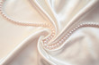 Smooth elegant white silk with pearls as wedding background Smooth elegant white silk with pearls as wedding background