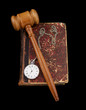 Judge's gavel and very old legal book with watch