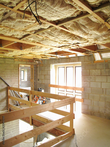 Photo: Exposed insulation in ceiling of house under construction Exposed insulation in ceiling of house under construction