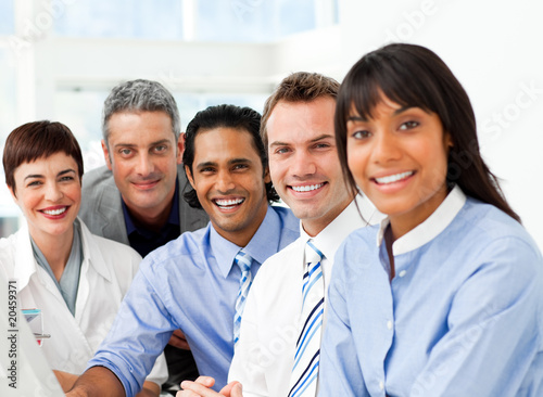 Photo: Portrait of ambitious business team at work Portrait of ambitious business team at work