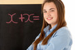 Female Student Standing Next To Blackboard Female Student Standing Next To Blackboard