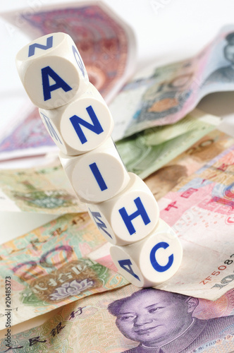 Stack of dices on chinese money.