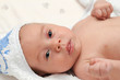 Baby lying in bed in a towel