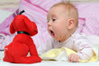 Happy baby playing with a toy