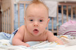 Happy baby crawling in bed