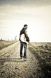 musician walking along the road