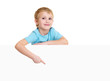 Cute male kid points on banner
