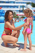 woman smears with cream for sunburn little girl