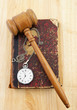Judge's gavel and very old legal book with watch