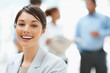 A business lady with colleagues discussing in the back