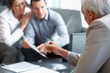 Financial planner explaining investment plans to clients Financial planner explaining investment plans to clients