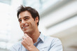 Smart young executive looking away with copyspace