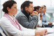 Business executives attending a seminar - paying attention Business executives attending a seminar - paying attention