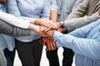 Mid section of united business people with hands together