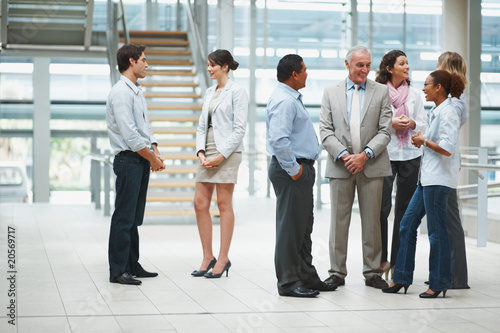Photo: Business team talking to each other during their break Business team talking to each other during their break