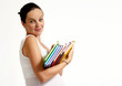The pregnant woman with books on a light background