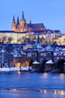 Snowy Prague gothic Castle with Charles Bridge in the Night Snowy Prague gothic Castle with Charles Bridge in the Night