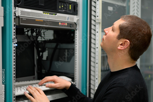 Photo: Network technician perform preventive maintenance to a server Network technician perform preventive maintenance to a server
