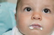 Closeup of baby boy's face with food around his mouth