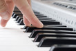 hand playing music on the piano