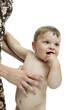 Naked baby boy held by young woman's hands