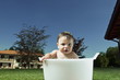 Baby boy taking bath in tub in garden