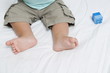 Closeup of baby's feet with block toy