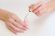 Woman brushing her fingernails with enamel Woman brushing her fingernails with enamel